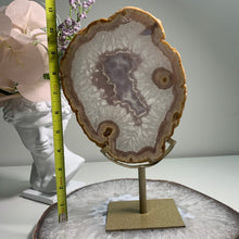 Load image into Gallery viewer, Rare - Agate slice in stand with nice pink druzy pattern in center
