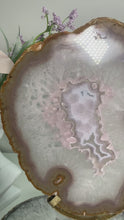 Load and play video in Gallery viewer, Rare - Agate slice in stand with nice pink druzy pattern in center
